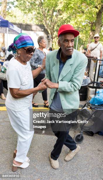 View of a couple as they dance at the fore of the audience during a performance at the 25th Annual Charlie Parker Jazz Festival in Harlem's Marcus...