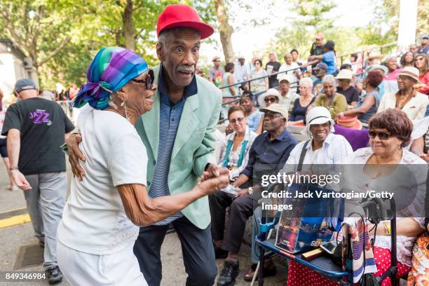 View of a couple as they dance at the fore of the audience during a performance at the 25th Annual Charlie Parker Jazz Festival in Harlem's Marcus...