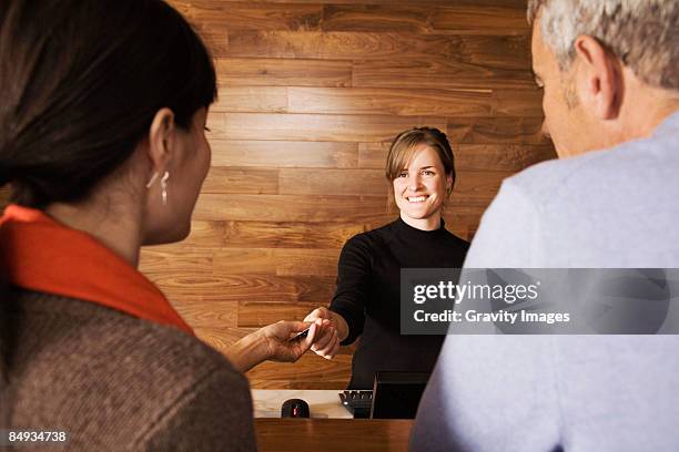 older couple checking into hotel - concierge stock-fotos und bilder