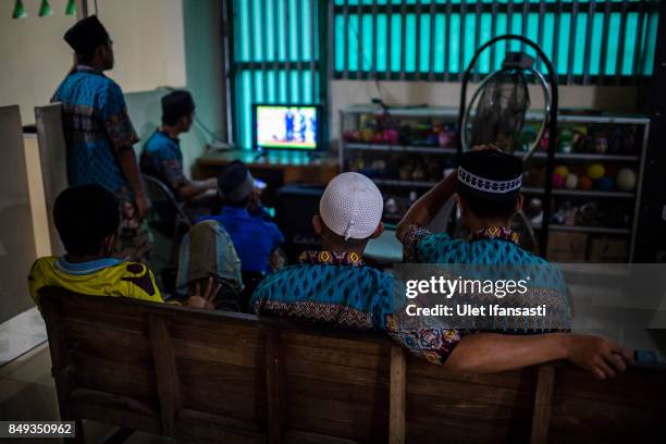 Recovering drug addicts watching television at the traditional rehabilitation centre Nurul Ichsan Al Islami on September 15, 2017 in Purbalingga,...