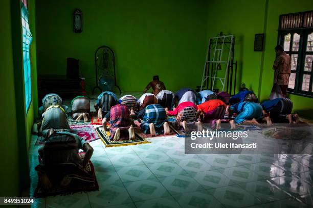 Recovering drug addicts praying at the traditional rehabilitation centre Nurul Ichsan Al Islami on September 15, 2017 in Purbalingga, Indonesia....