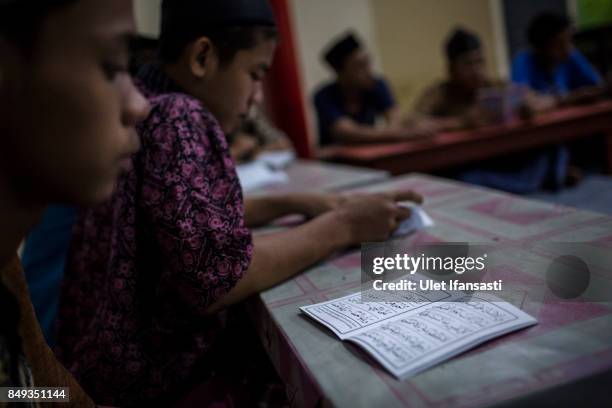 Recovering drug addicts reading Quran during a prayer session led by Ustad Ahmad Ischsan Maulana, the head of Nurul Ichsan Al Islami traditional...