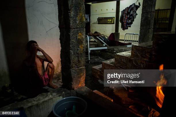 Recovering drug addict waits for his herbal hot water immersion treatment by the head of rehabilitation centre, Ustad Ahmad Ischsan Maulana at the...