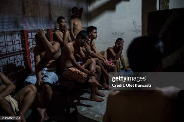 Recovering drug addicts wait for their herbal hot water immersion treatment by the head of rehabilitation centre, Ustad Ahmad Ischsan Maulana at the...
