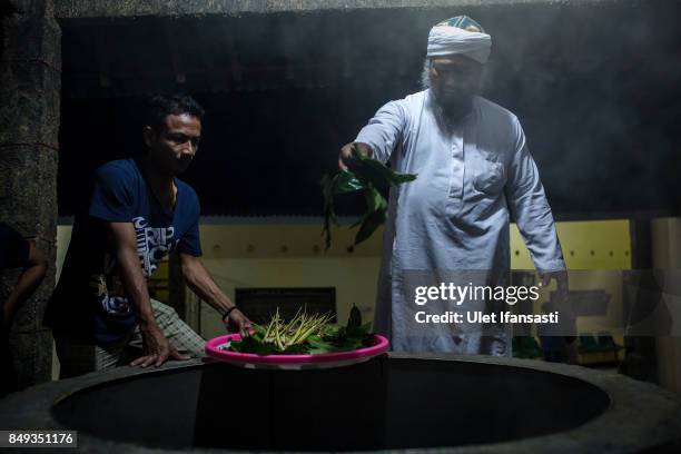 Ustad Ahmad Ischsan Maulana, the head of Nurul Ichsan Al Islami traditional rehabilitation centre, prepares a hot water herbal bath for recovering...