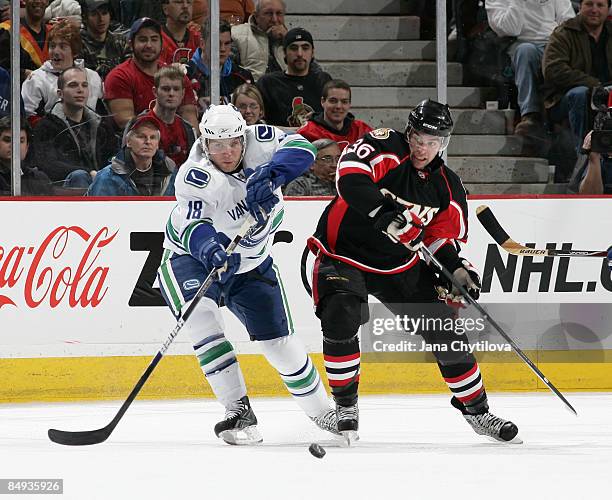 Josh Hennessy of the Ottawa Senators battles for the puck against Steve Bernier of the Vancouver Canucks at Scotiabank Place on Feburary 19, 2009 in...