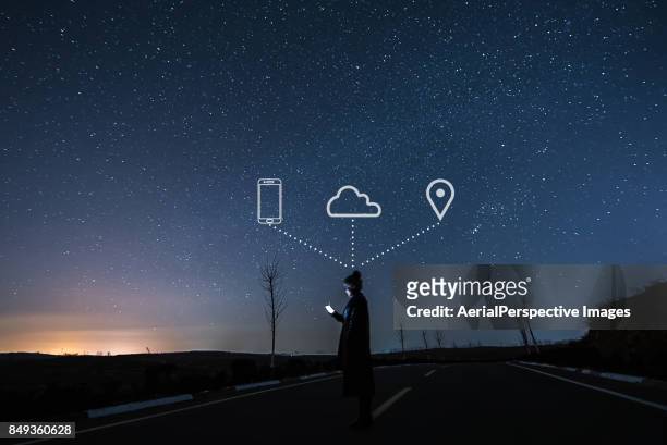woman using smartphone in starry night - mobile phone reading low angle stock pictures, royalty-free photos & images