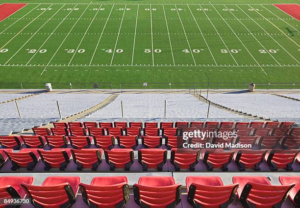 empty football field and stadium seats. - american football pitch stock-fotos und bilder