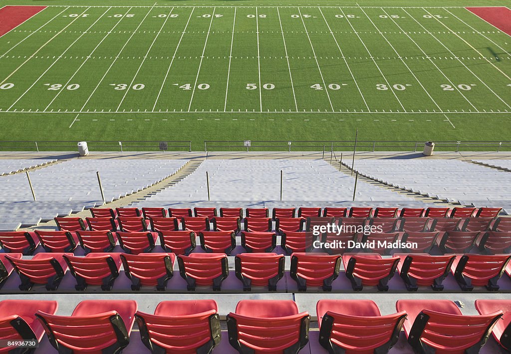 Empty football field and stadium seats.