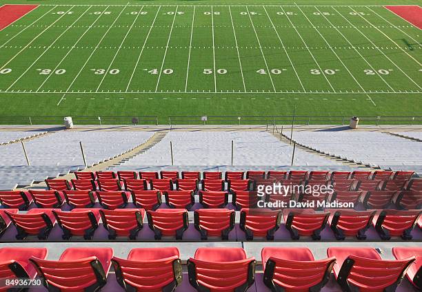 empty football field and stadium seats. - american football field stock pictures, royalty-free photos & images