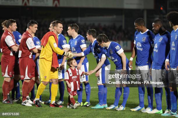 The two sets of players shake hands before the game