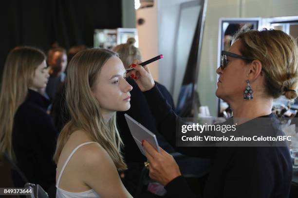 Model has makeup applied backstage ahead of the Emilio de la Morena show during London Fashion Week September 2017 on September 19, 2017 in London,...