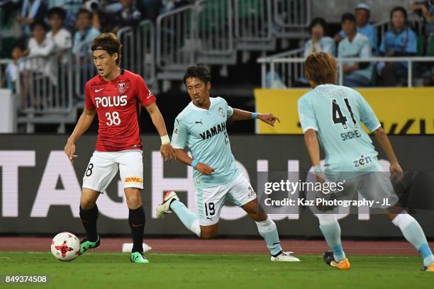 Daisuke Kikuchi of Urawa Red Diamonds and Hiroki Yamada of Jubilo Iwata compete for the ball during the J.League J1 match between Jubilo Iwata and...