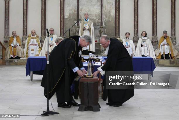 The Very Reverend Dr. Robert Willis, Dean of Canterbury Cathedral, watches the Reciever General, Brigadier John Meardon and a representative from the...