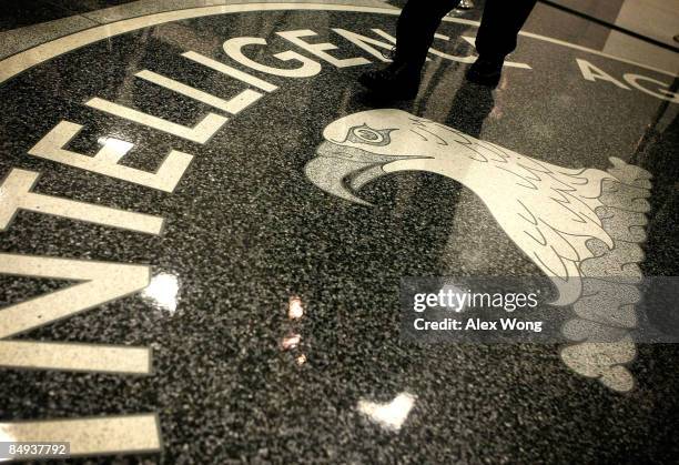 Man walks across the seal of the Central Intelligence Agency at the lobby of the Original Headquarters Building at the CIA headquarters February 19,...