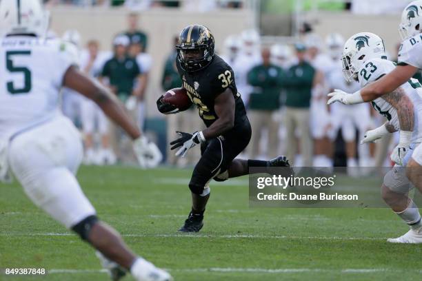 Running back Jamauri Bogan of the Western Michigan Broncos rushes against the Michigan State Spartans during the second half at Spartan Stadium on...