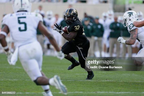 Running back Jamauri Bogan of the Western Michigan Broncos rushes against the Michigan State Spartans during the second half at Spartan Stadium on...