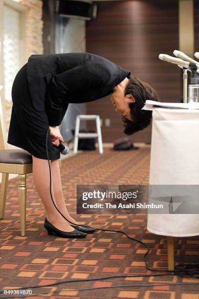 Lower house lawmaker Mayuko Toyota bows for apology during a press conference after the meeting with her supporters t her constituency on September...