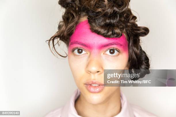 Model poses for a photo backstage ahead of the minki presentation during London Fashion Week September 2017 on September 19, 2017 in London, England.