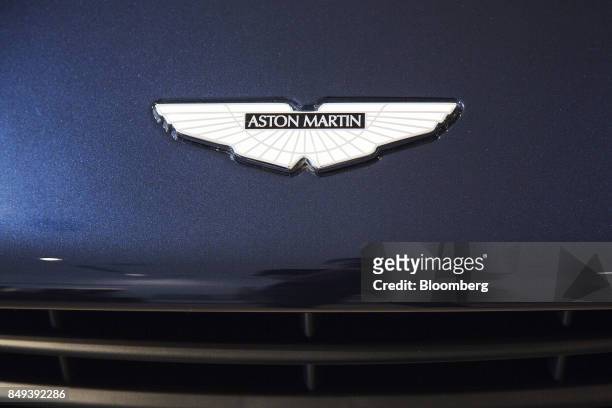 Badge sits on the hood of an Aston Martin Vanquish luxury automobile on display at an Aston Martin Lagonda Ltd. Showroom in Singapore, on Tuesday,...