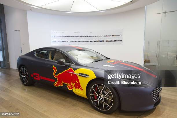 An Aston Martin Rapide S luxury automobile featuring Red Bull GmbH branding sits on display at an Aston Martin Lagonda Ltd. Showroom in Singapore, on...