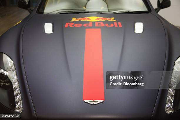 An Aston Martin Rapide S luxury automobile featuring Red Bull GmbH branding sits on display at an Aston Martin Lagonda Ltd. Showroom in Singapore, on...