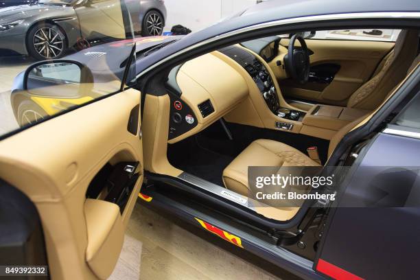 The interior of an Aston Martin Rapide S luxury automobile featuring Red Bull GmbH branding is seen at an Aston Martin Lagonda Ltd. Showroom in...