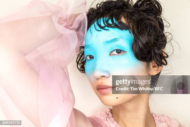 Model poses for a photo backstage ahead of the minki presentation during London Fashion Week September 2017 on September 19, 2017 in London, England.