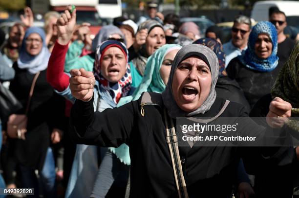 Refugees protest outside the Asylum Service in Athens on September 19 to call for immediate reunifications with their families in Germany. Refugees ,...