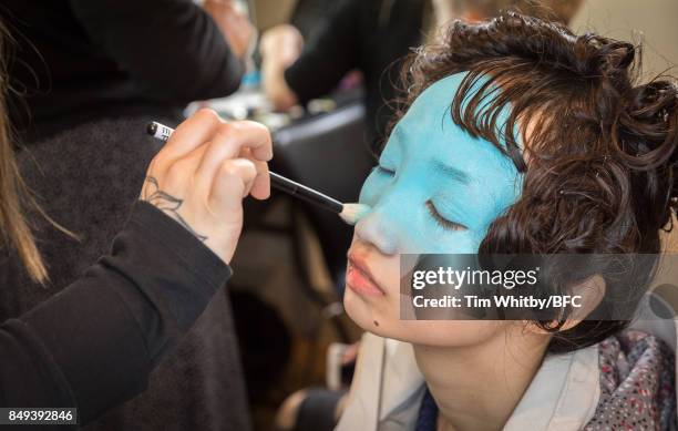 Model prepares backstage ahead of the minki presentation during London Fashion Week September 2017 on September 19, 2017 in London, England.