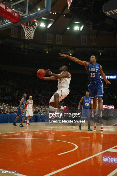Malik Booth of St. John's Red Storm goes for the basket while Gerald Henderson for Duke Blue Devils tries to block on February 19, 2009 at Madison...