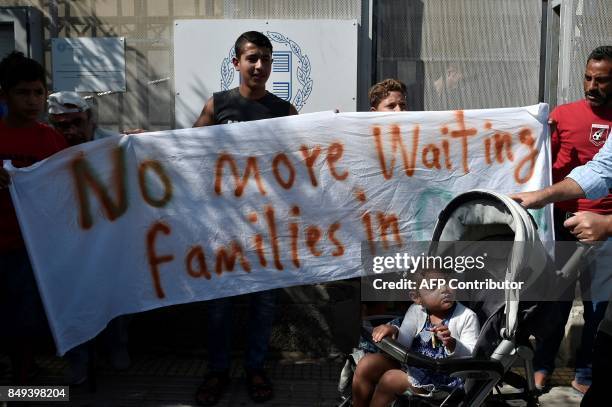 Refugees protest outside the Asylum Service in Athens on September 19 to call for immediate reunifications with their families in Germany. Refugees ,...