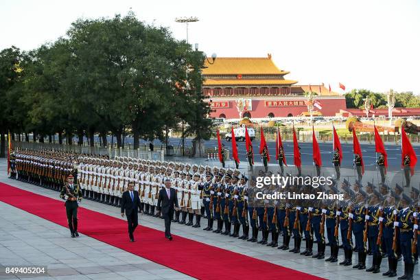 Chinese Premier Li Keqiang invites Singapore Prime Minister, Lee Hsien Loong to view a guard of honour during a welcoming ceremony outside the Great...