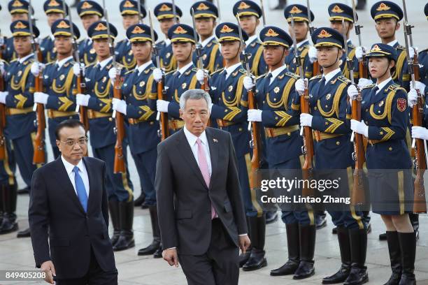 Chinese Premier Li Keqiang invites Singapore Prime Minister, Lee Hsien Loong to view a guard of honour during a welcoming ceremony outside the Great...