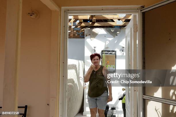 Eleanor Mota walks through her roofless home more than a week after Hurricane Irma made landfall, on September 18, 2017 in Charlotte Amalie, St...