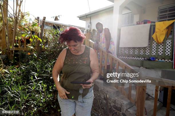 Eleanor Mota finishes sharing news of Hurricane Maria with her neighbor more than a week after Hurricane Irma made landfall, on September 18, 2017 in...