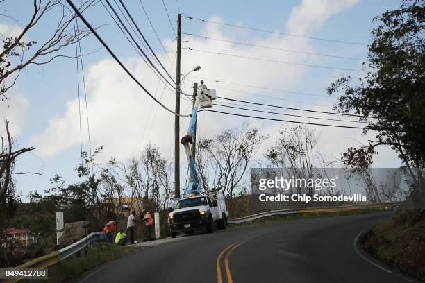 Linemen scramble to repair power lines and restore electric service more than a week after Hurricane Irma made landfall, on September 18, 2017 in...
