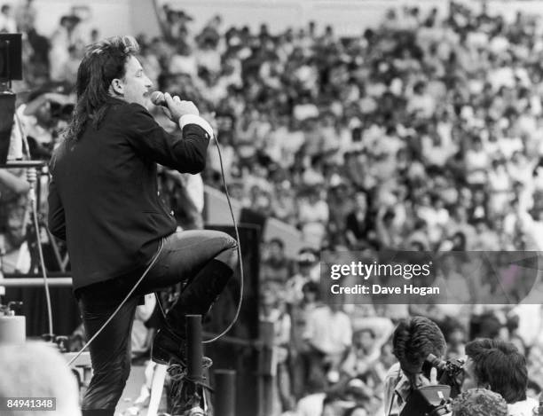 Irish singer Bono performing with U2 at the Live Aid charity concert, Wembley Stadium, London, 13th July 1985.