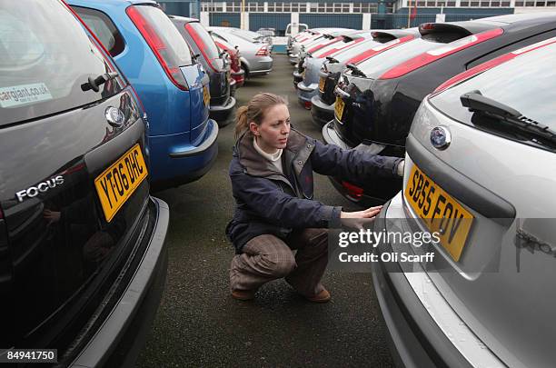 In this photo illustration, a customer views the cars on sale at Cargiant, the world's largest car supermarket, in White City on February 19, 2009 in...