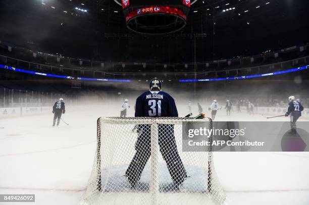 Vancouver Canucks' goaltender Andres Nilsson guards his post during an ice hockey practice session for the 2017 NHL China Games in Shanghai on...