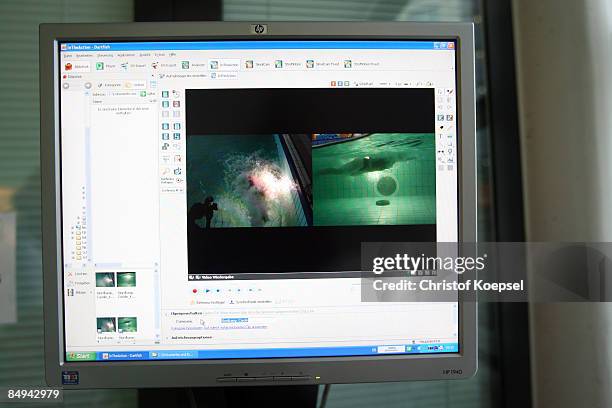 The swimming of a triathlete against a counter-current system is filmed and monitored on a computer during a sports performance diagnostic at the...