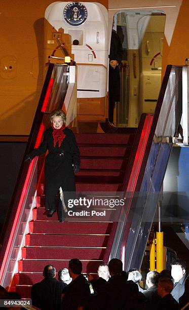 Secretary of State Hillary Clinton walks down stairs from a plane as she arrives February 20, 2009 in Beijing, China, Clinton is on a three-day-visit...