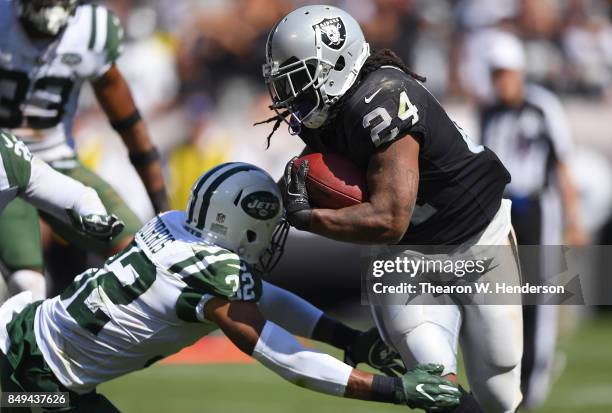 Marshawn Lynch of the Oakland Raiders breaks the tackle of Juston Burris of the New York Jets during the second quarter of their NFL football game at...