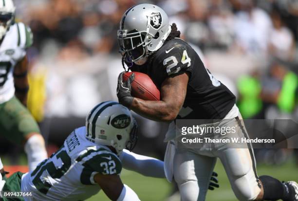 Marshawn Lynch of the Oakland Raiders breaks the tackle of Juston Burris of the New York Jets during the second quarter of their NFL football game at...