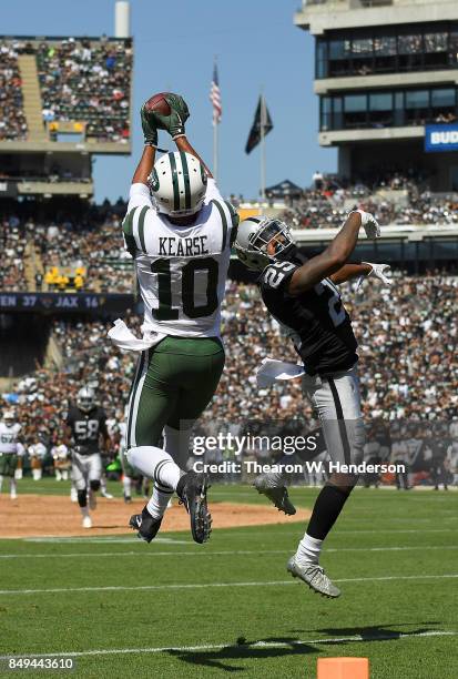 Jermaine Kearse of the New York Jets catches a thirty four yard touchdown pass over David Amerson of the Oakland Raiders during the second quarter of...