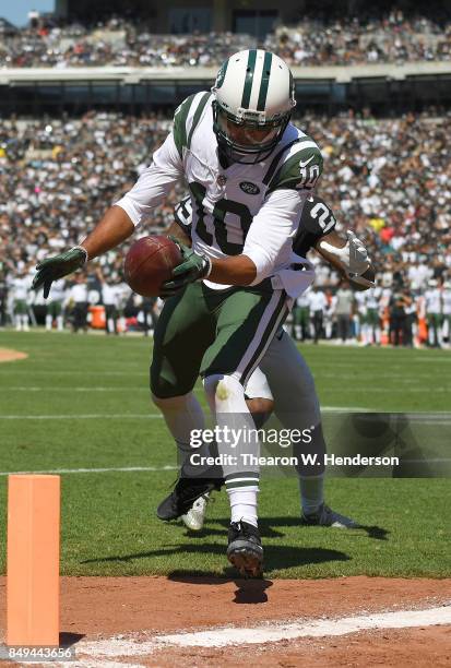 Jermaine Kearse of the New York Jets scores on a thirty four yard touchdown pass over David Amerson of the Oakland Raiders during the second quarter...