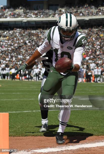 Jermaine Kearse of the New York Jets scores on a thirty four yard touchdown pass over David Amerson of the Oakland Raiders during the second quarter...