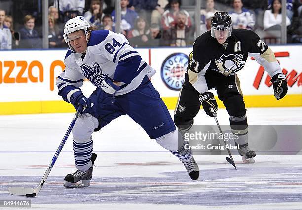 Mikhail Grabovski of Toronto Maple Leafs skates the puck away from Evgeni Malkin of the Pittsburgh Penguins during game action February 14, 2009 at...