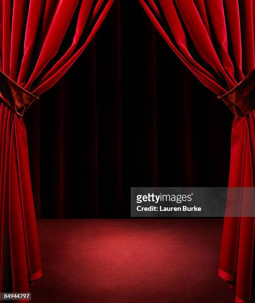 spotlight on empty stage with red velvet curtains - curtain fotografías e imágenes de stock