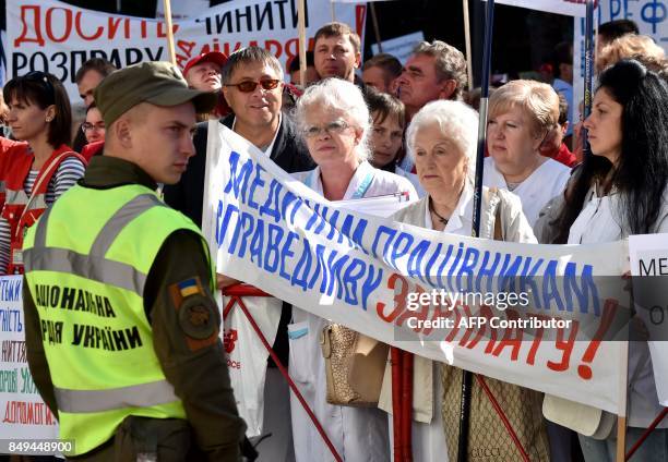 Demonstrators take part in a protest as part of a nation-wide action day of the Ukrainian Health Care Workers' Union against a health reform bill on...